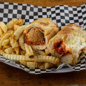 Meatball parmesan sandwich with fries