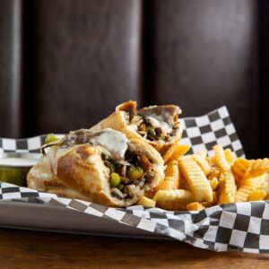 Philly steak bomb sandwich with fries
